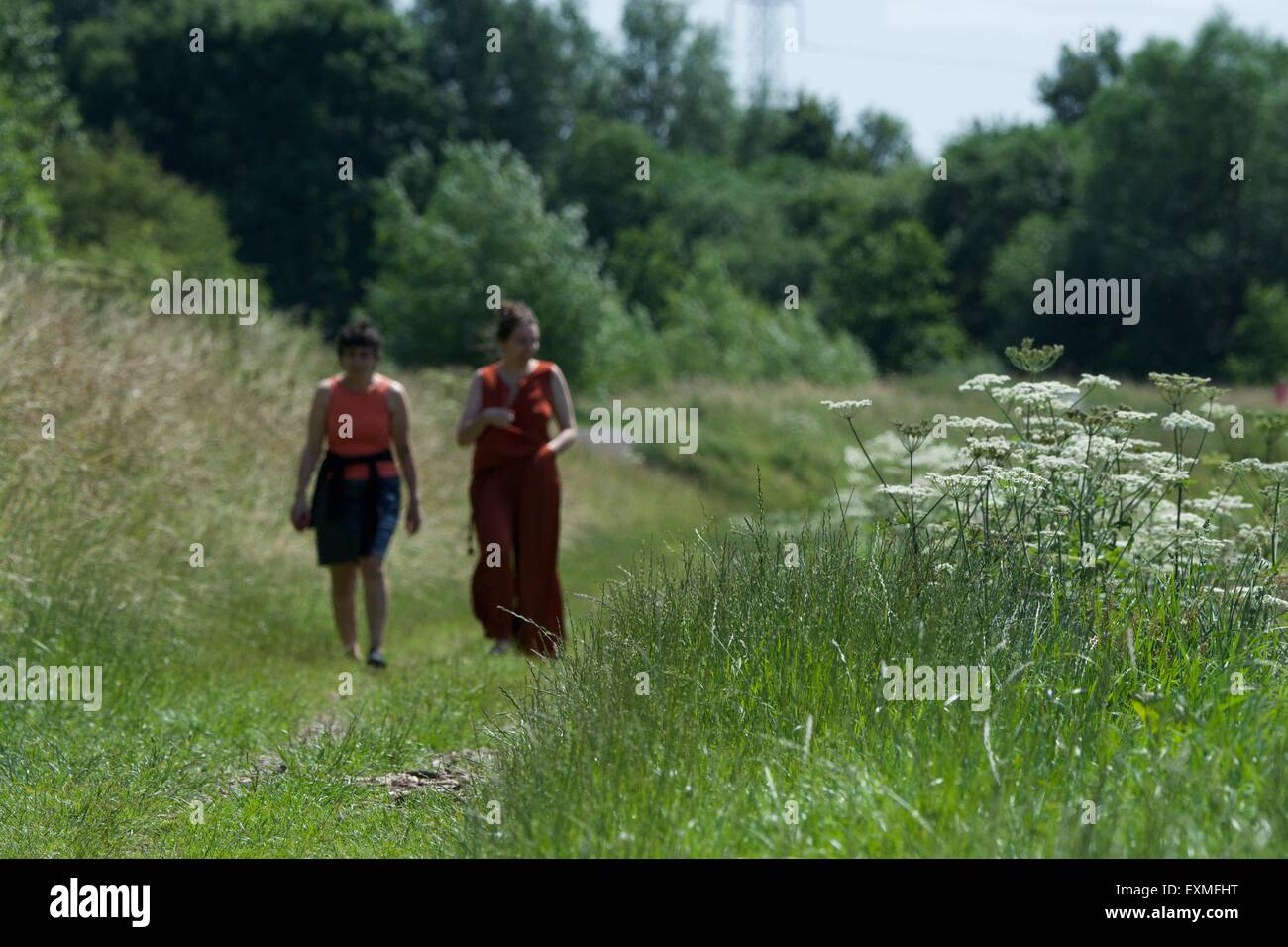 Two women walk along a path along the banks of the the River Mersey as it passes between Didsbury and Northenden in south Manchester. Stock Photo