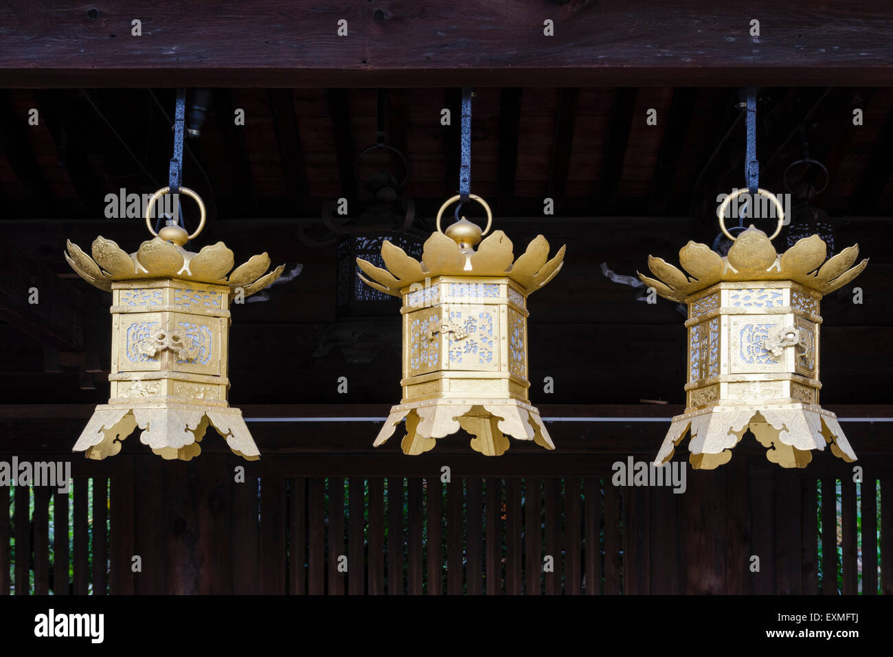 Three lanterns hanging from the eves of the Kitano Tenmangu Shrine, Kyoto, Japan Stock Photo