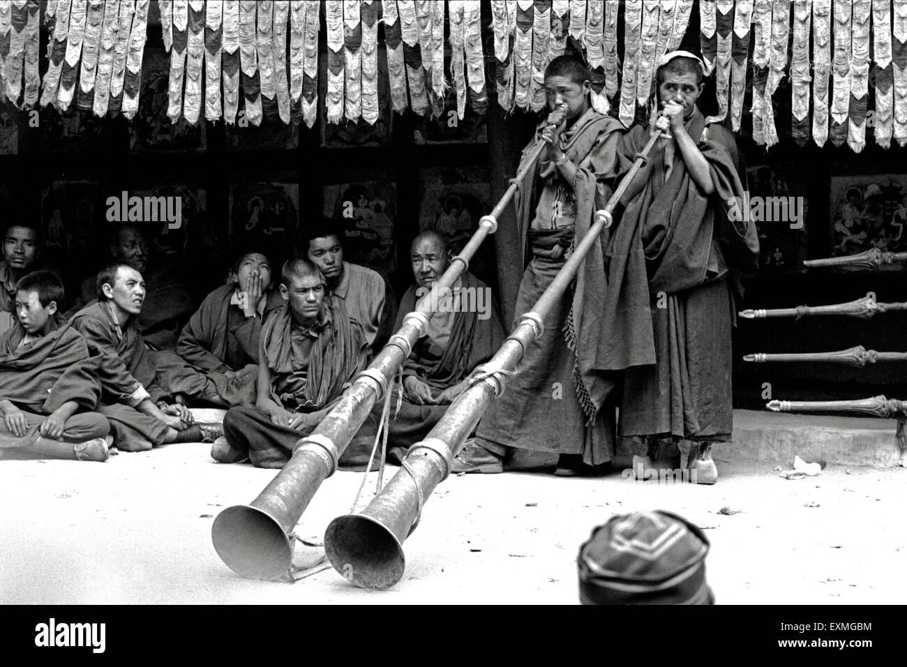 Buddhist monks blowing musical instruments Tibetan horn, Hemis Festival, Hemis gompa, Hemis Monastery, Himalayan monastery, Hemis, Leh, Ladakh, Jammu and Kashmir, Union Territory, UT, India, Asia, old vintage 1900s picture Stock Photo