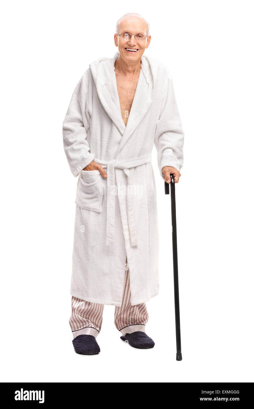 Full length portrait of a senior man in a bathrobe holding a cane and  looking at the camera isolated on white background Stock Photo - Alamy