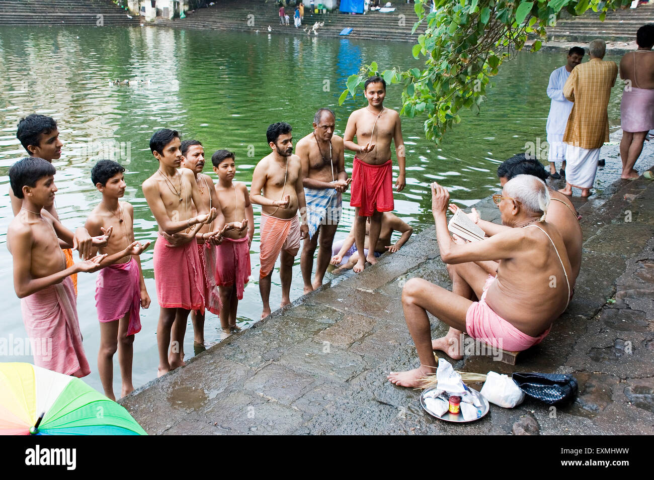 Janoi (Sacred Thread) changing Ritual of Hindu Brahmins coconut Purnima day Banganga Tank ; Walkeshwar Mumbai Stock Photo