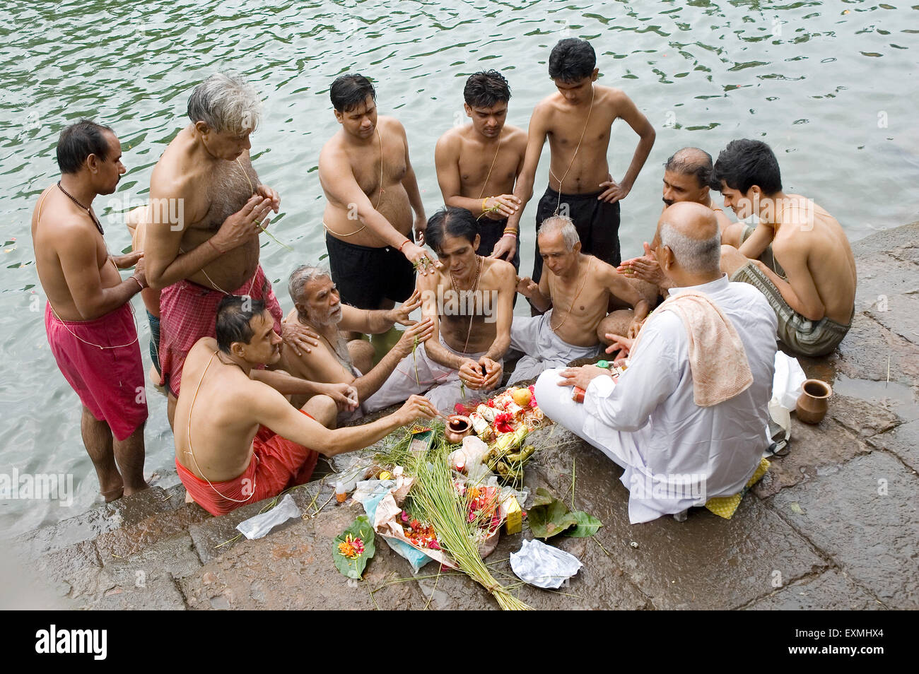 Janoi (Sacred Thread) changing Ritual of Hindu Brahmins on a coconut on Purnima day Banganga Tank Walkeshwar Mumbai Stock Photo