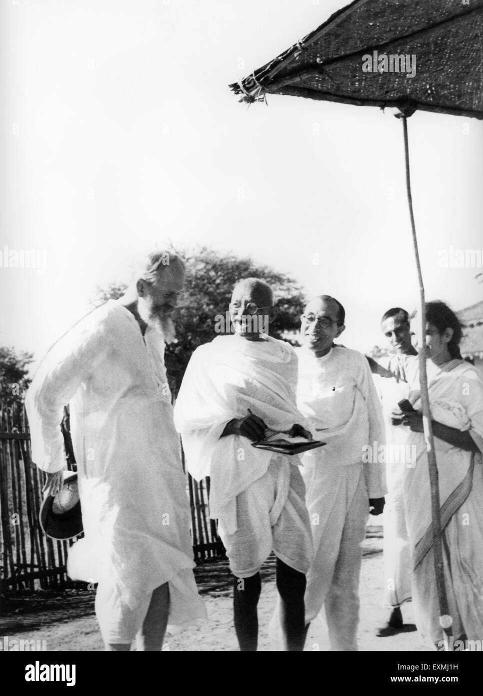Mahatma Gandhi laughing with CF Andrews (left) Pyarelal Nayar and others at Sevagram Ashram Wardha near Nagpur Maharashtra India Asia 1939 old vintage 1900s picture Stock Photo