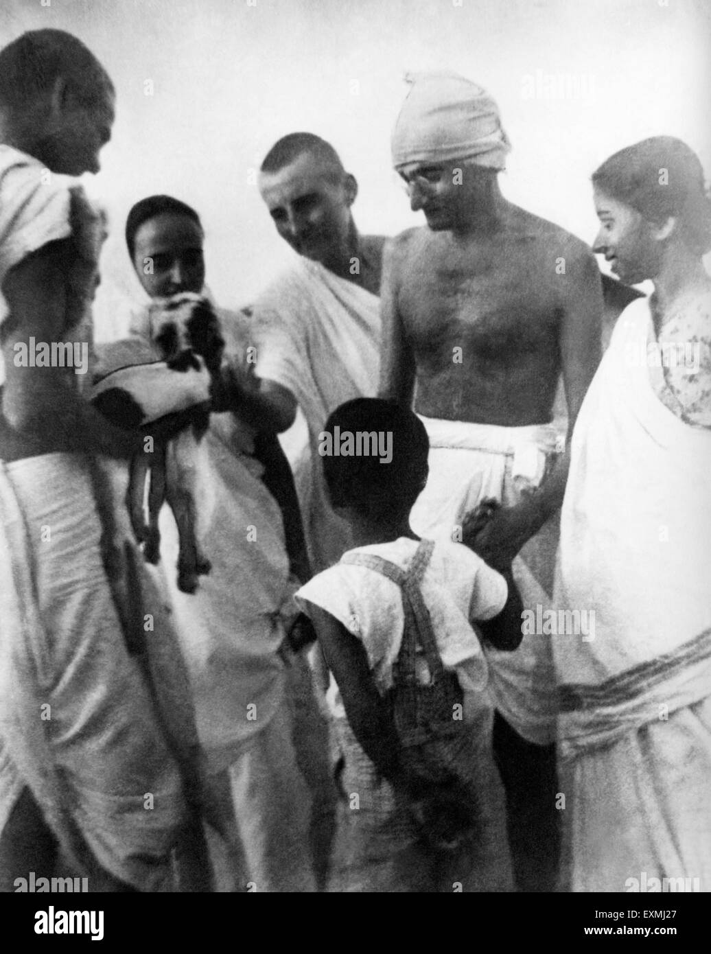 Balwant Singh presenting newborn two hours old goat to Mahatma Gandhi grandson Kahandas hand Sevagram Ashram Stock Photo