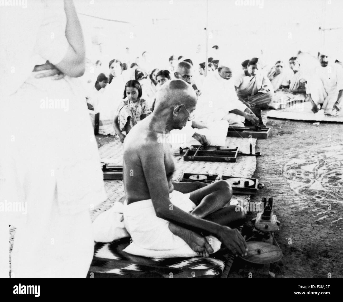 Mahatma Gandhi spinning during a gramseva village service camp at Sevagram Ashram Wardha Nagpur India1945 old vintage 1900s picture Stock Photo