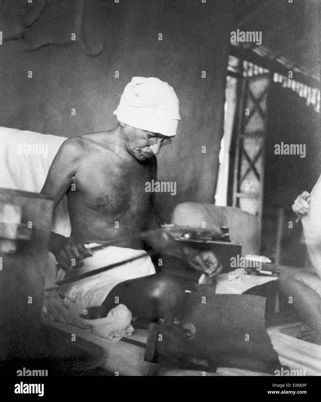 Mahatma Gandhi spinning on Dhanush Takli spinning instrument in his hut