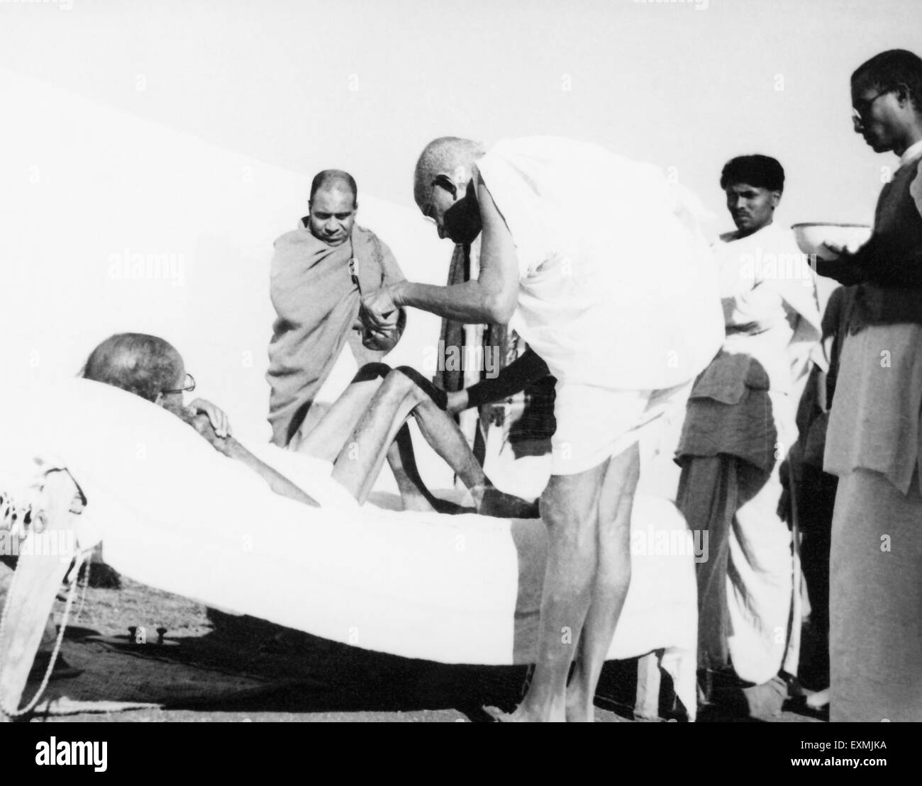 Mahatma Gandhi giving massage leper patient Sanskrit scholar Parchure Shastri at Sevagram Ashram ; 1940 ; Shankaran Stock Photo