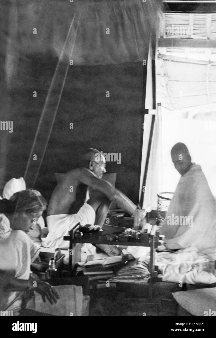 Mahatma Gandhi ; working in the office hut at Sevagram Ashram ; 1944 ; Sushila Pai (worker at the ashram office) NO MR Stock Photo