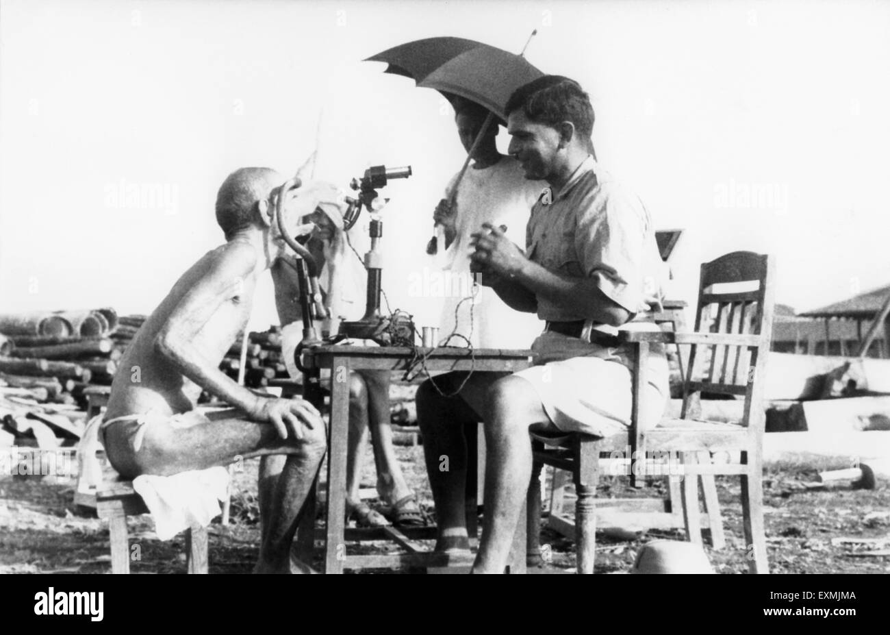 Parchure Shastri, leprosy patient Sanskrit scholar being examined, Sevagram Ashram, Sewagram, Wardha, Nagpur, Maharashtra, 1940, India, Asia, old vintage 1900s picture Stock Photo