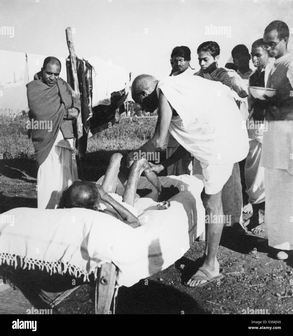 Mahatma Gandhi ; nursing leper patient Parchure Shastri at Sevagram Ashram ; 1940 NO MR Stock Photo