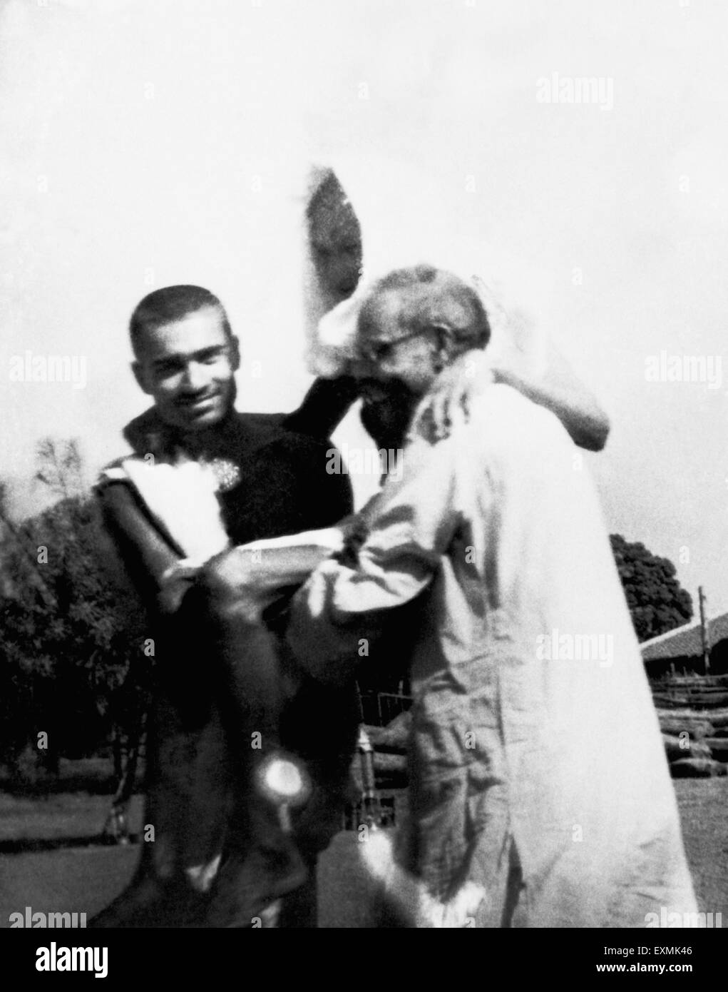 Kanu Gandhi and Dr. Das carrying Mahatma Gandhi ; who is on the 3rd day of his fast at Sevagram Ashram ; 1941 NO MR Stock Photo
