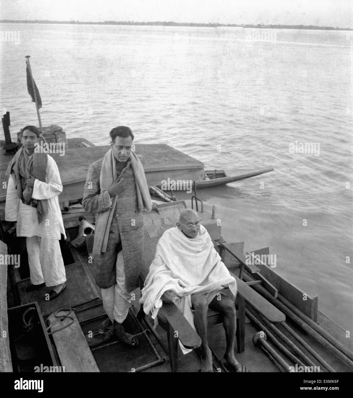 Sudhir Ghosh ; Ramkrishna Bajaj and Mahatma Gandhi on a boat on the way to Midnapur (East Bengal) ; December 1945 NO MR Stock Photo