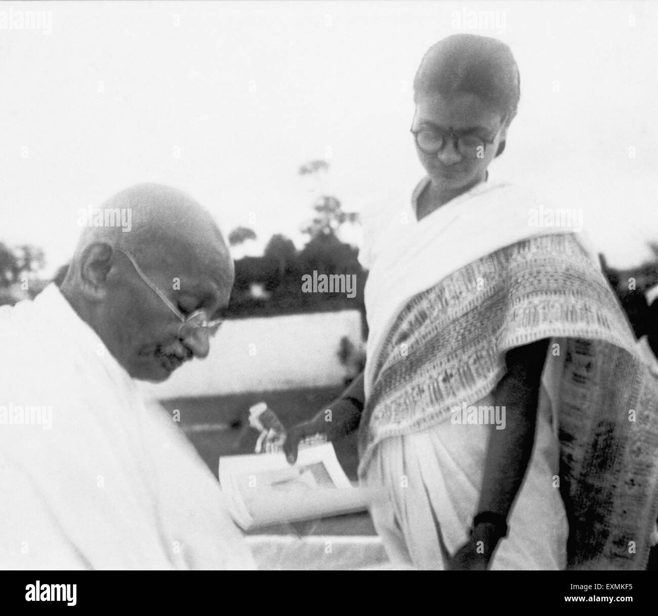 After prayer Mahatma Gandhi gives an autograph ; Pune ; 2nd Oct 1944 NO MR Stock Photo