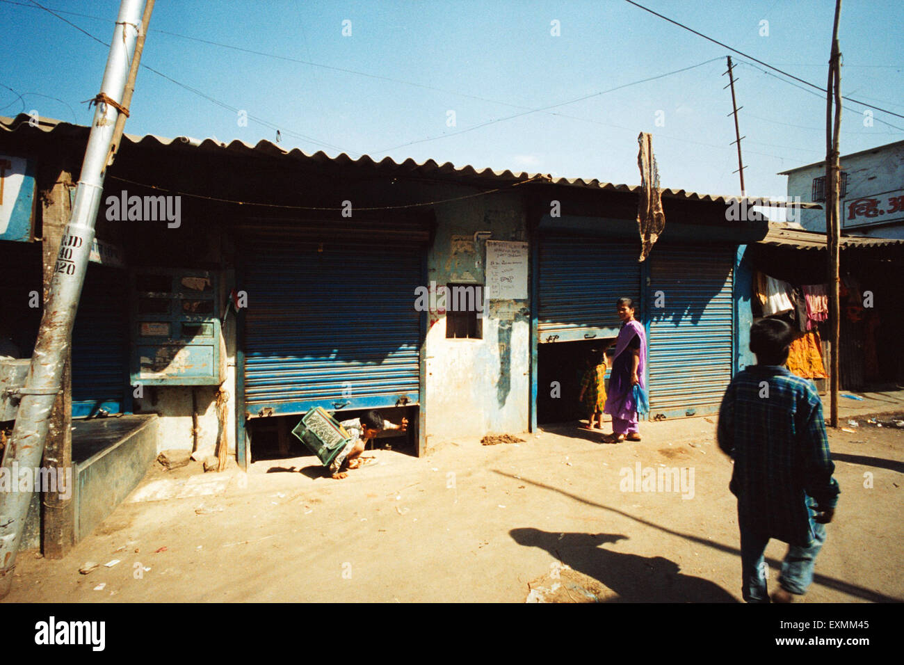 Shops closed with aluminium rolling shutters, Dharavi, Bombay, Mumbai