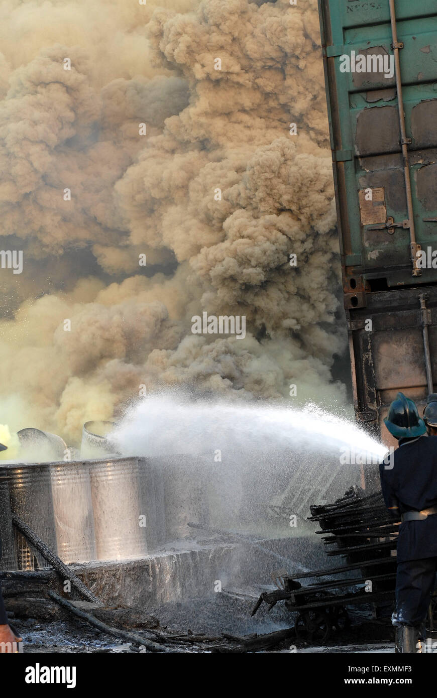 Fire brigade personnel or fire fighters trying to extinguish fire in