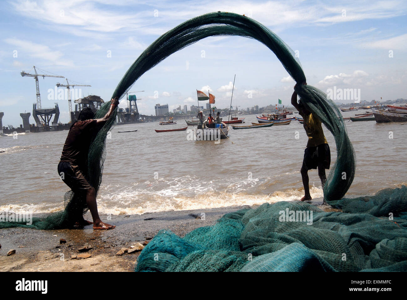 Fishermen cleaning fishing nets ; fisherman working ; Worli Village