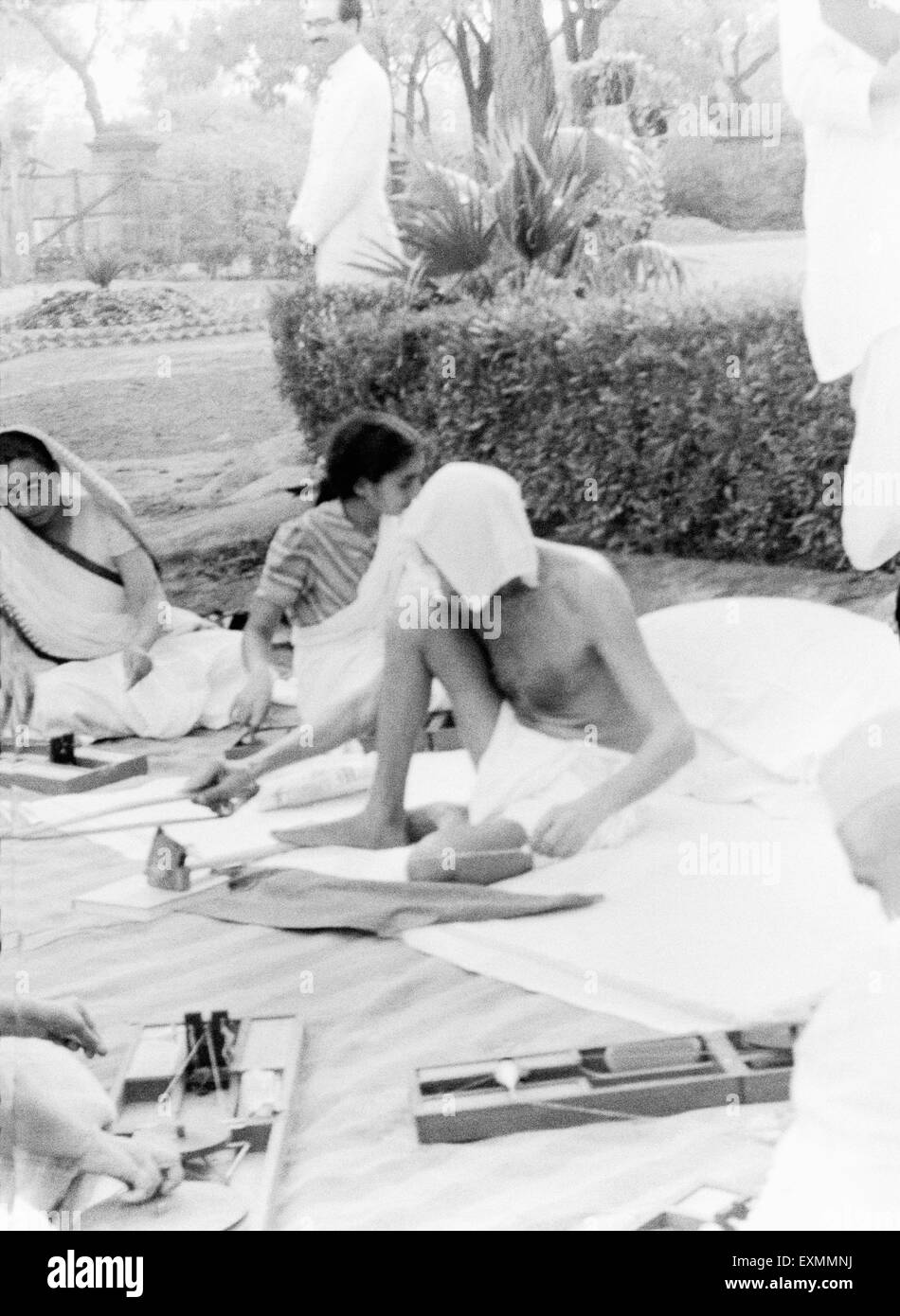 Mahatma Gandhi spinning ; New Delhi ; 1939 ; Sushila Nayar ; Mahadev Desai ; India NO MR Stock Photo