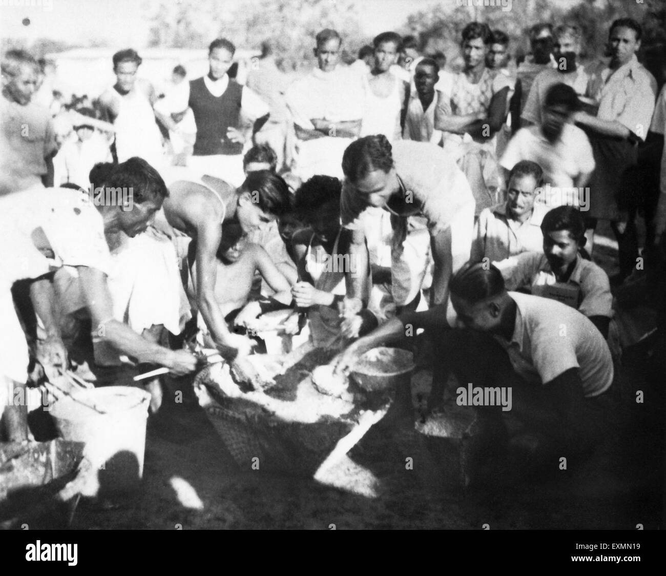 Free food distribution after riots, India, Asia, Indian old black and white vintage 1900s picture Stock Photo