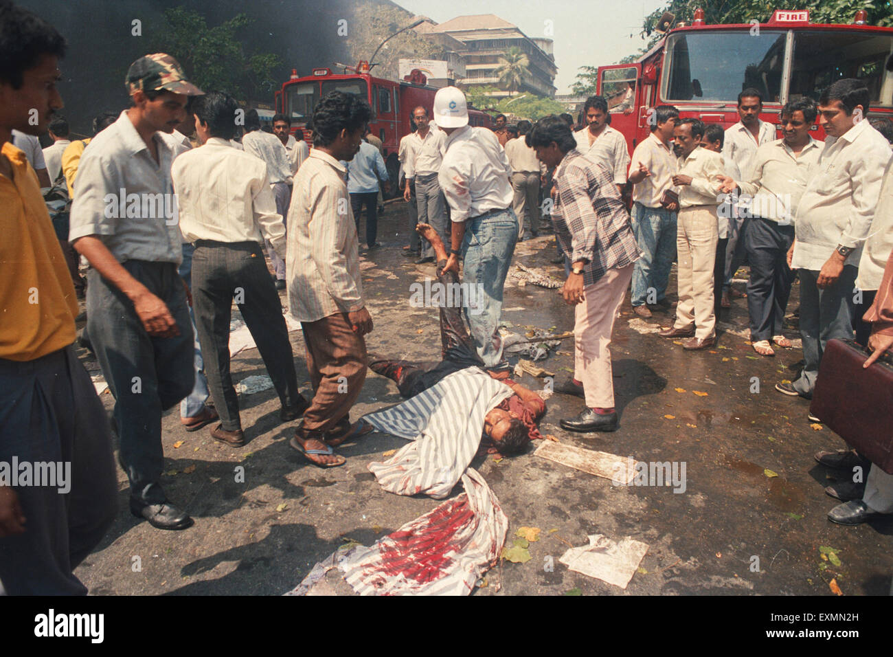 Dead man terror bomb blast 1993 Helping victim terror bomb blast 1993 Bombay Mumbai Maharashtra India 1900 1900s Mumbai attack Mumbai terror 1993 Bombay bombings 12 March 1993 Stock Photo