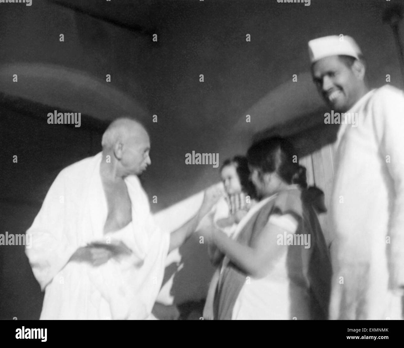 Mahatma Gandhi ; Uma Om Agarwal and Radhakrishna Bajaj in Wardha ; 1945 ; India ; old vintage 1900s picture Stock Photo