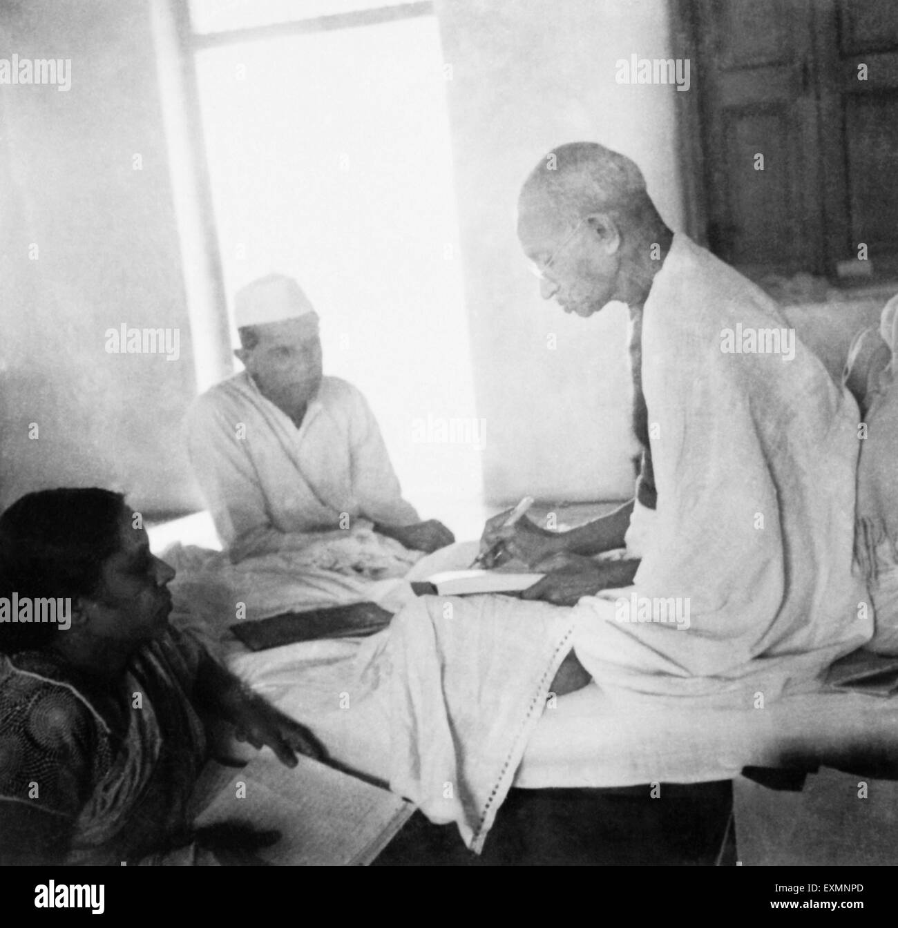 Mahatma Gandhi just after breaking his fast at Rashtriyashala Ashram Rajkot March 1939 Next to Mahatma Gandhi Jamnadas Gandhi Stock Photo