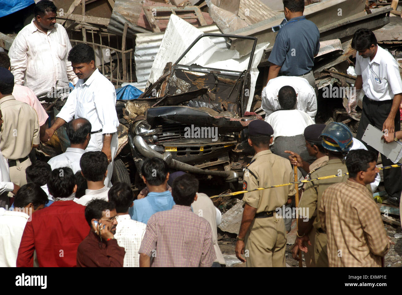 Officers from police bomb squad inspecting remain of taxi blast took place at Zaveri bazaar Kalbadevi area Bombay Mumbai India Stock Photo