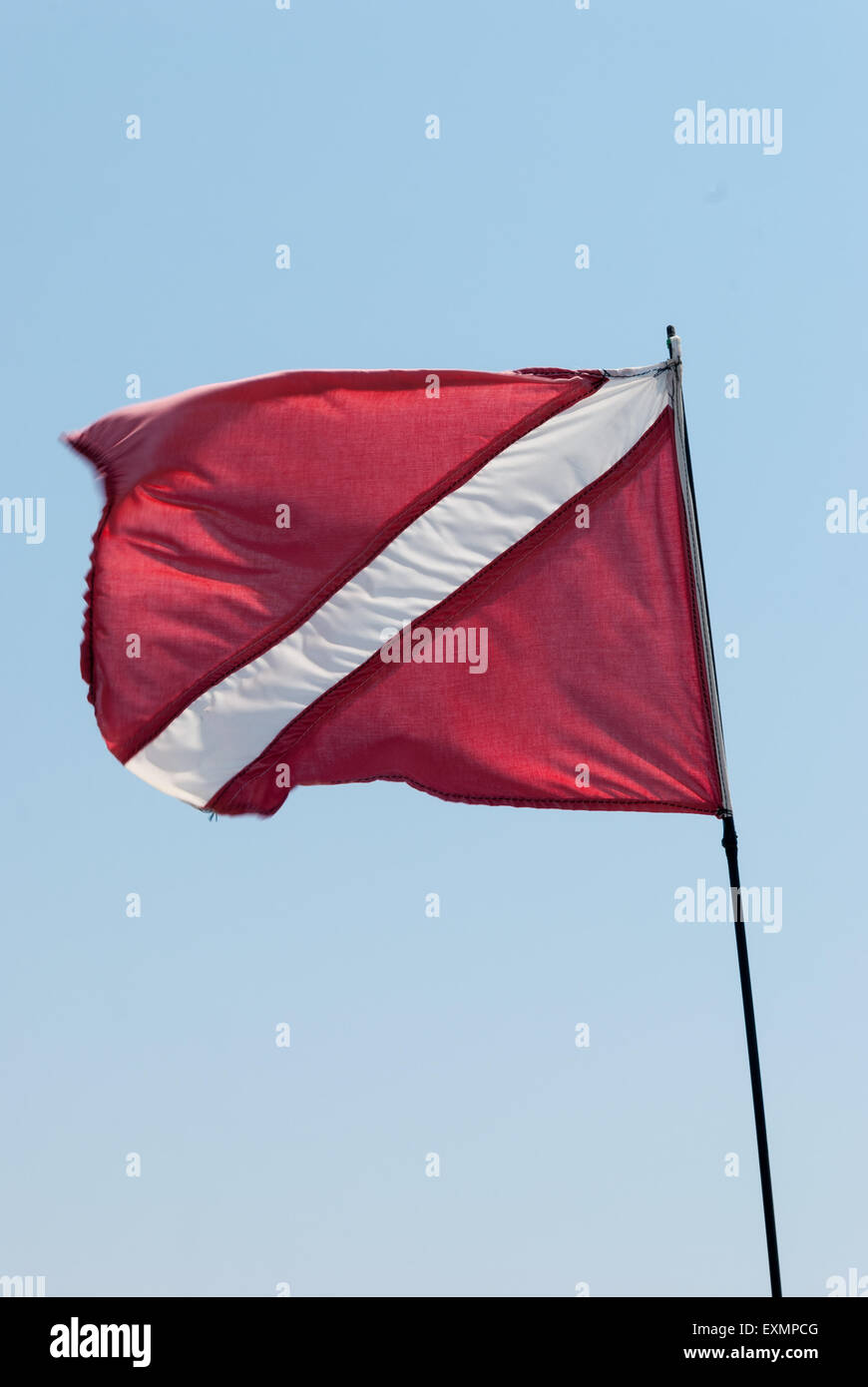 Scuba Dive Flag on the wind with blue sky as a background Stock Photo