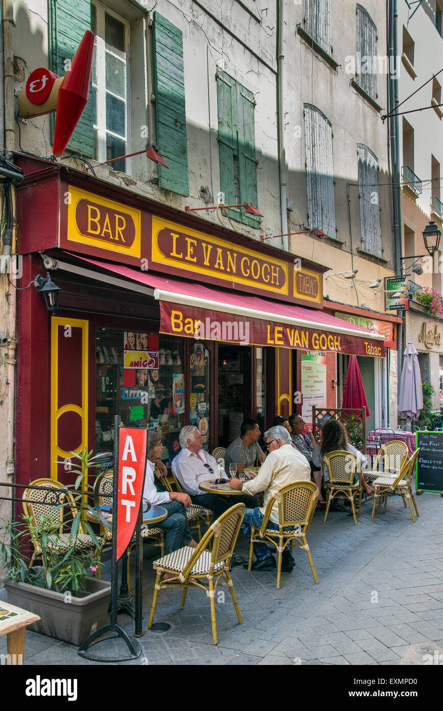 Outdoor cafe bar with people seated at tables, L’Isle-sur-la-Sorgue, Provence, France Stock Photo