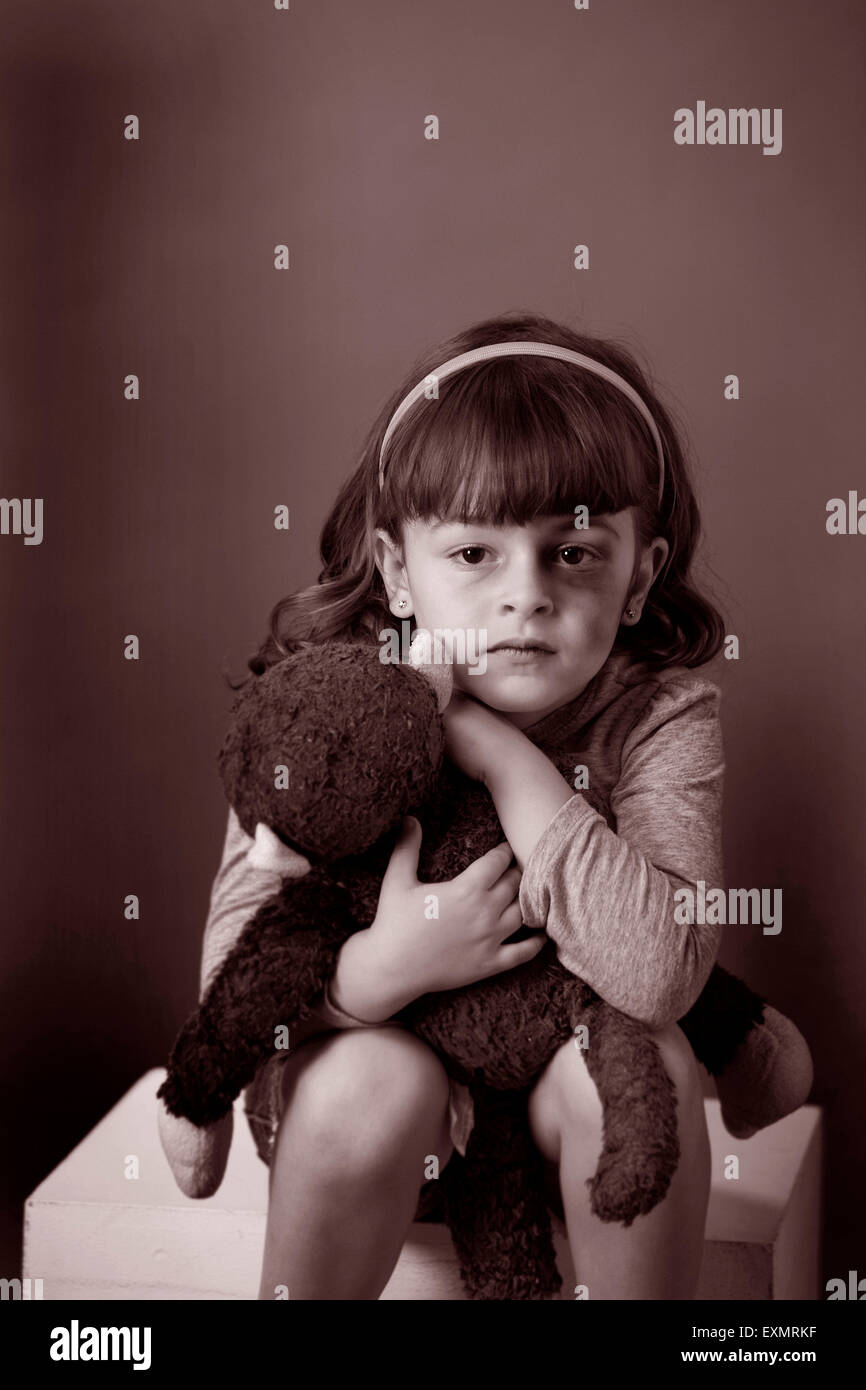 Portrait of young girl with a bruise or black eye on her left side ...