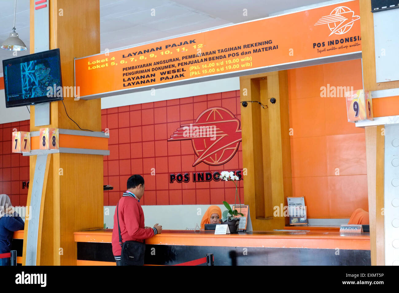 customer at a service desk at the main post office in malang java indonesia Stock Photo