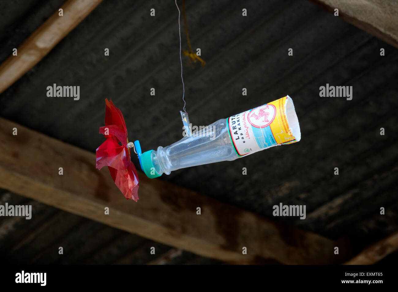 homemade wind driven toy made from empty plastic bottle used as a decoration outside a house in a village in java indonesia Stock Photo