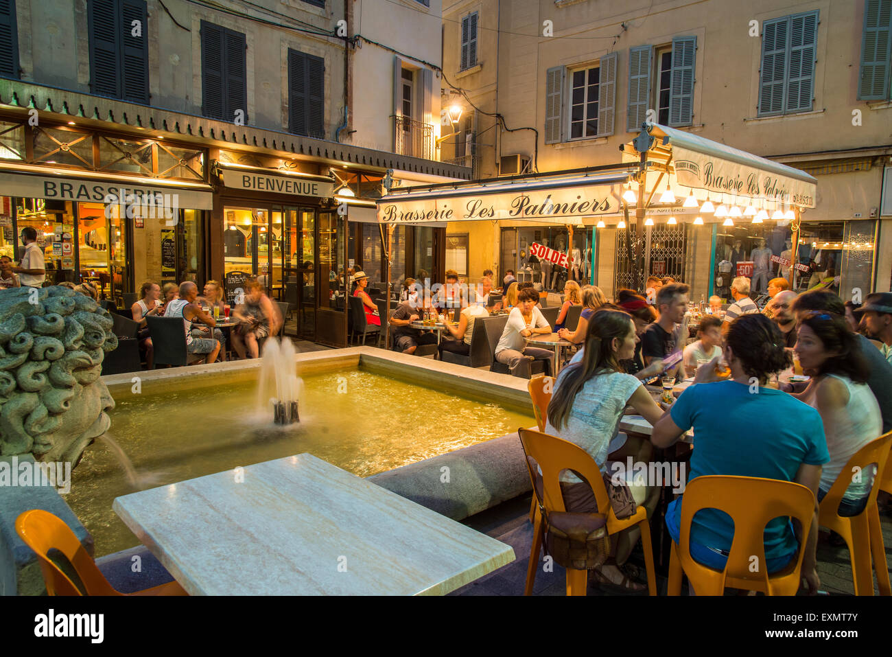 Night view of a Brasserie cafe restaurant with people seated outside at tables, Carpentras, Provence, France Stock Photo