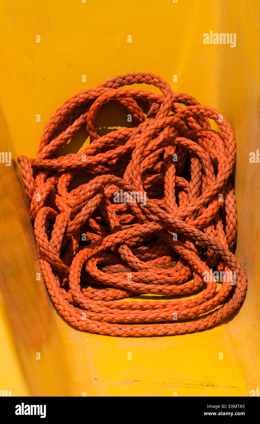 Orange long rope laying on the yellow deck of fishing boat Stock Photo ...