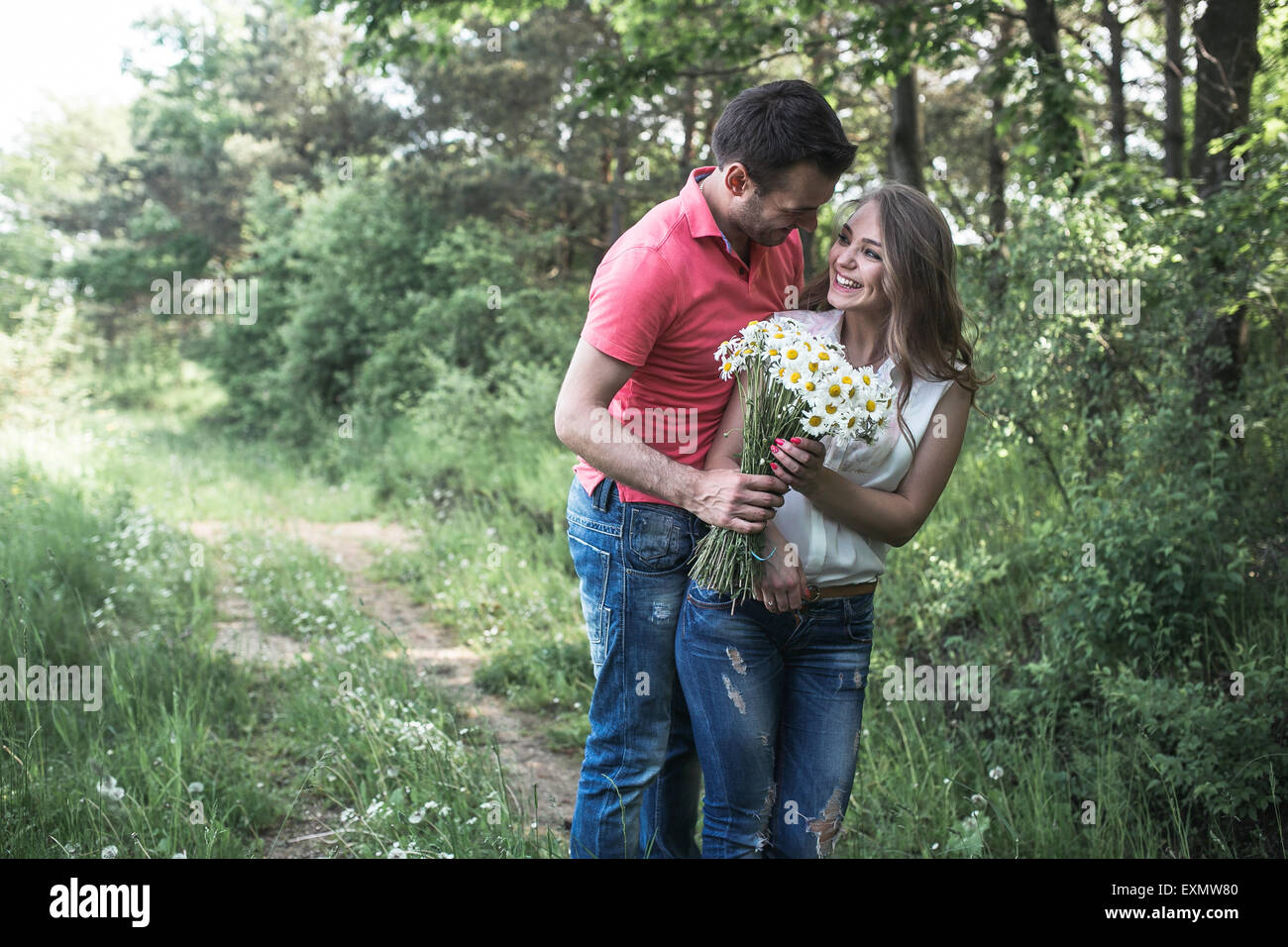Cute couple in a forest Stock Photo - Alamy