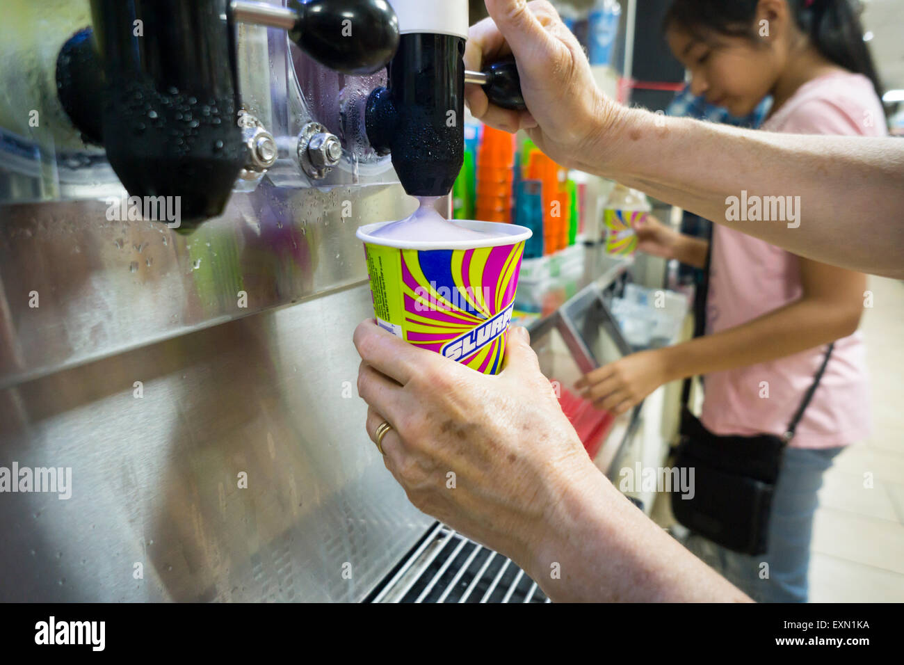 Slurpee lovers take advantage of Free Slurpee Day at a 7-Eleven store in New York on Saturday, July 11, 2015 (7-11, get it?). The 7-Eleven self-proclaimed Free Slurpee Day has been a yearly event for the past 13 years giving away free 7oz Slurpees. The popular icy, slushy, syrupy drinks are available in regular and diet flavors, in combinations, and the stores have stocked up with extra barrels of syrup to meet the expected demand. The 88 year old chain expects to serve over 8 million Slurpees today. (© Richard B. Levine) Stock Photo