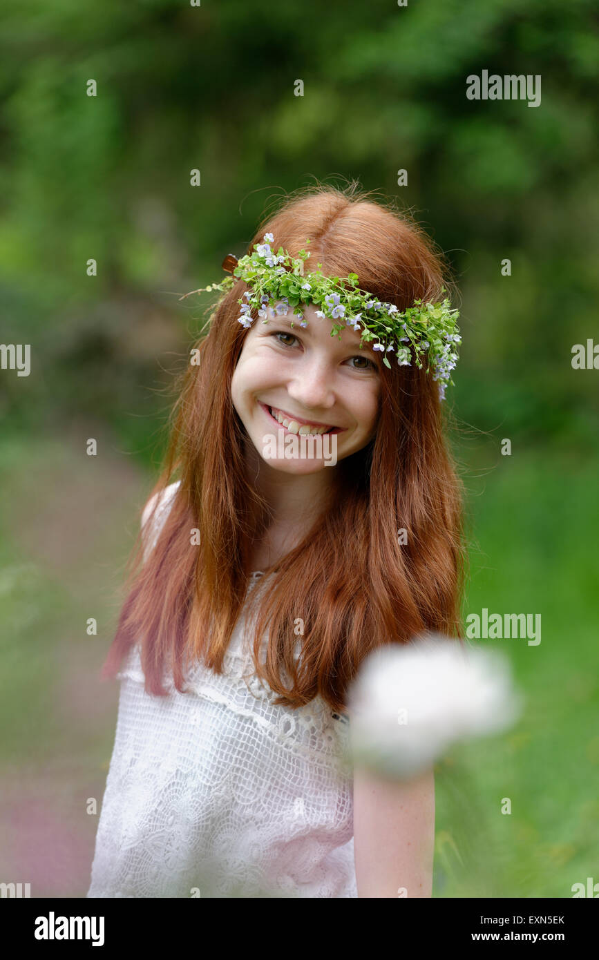 Portrait of smiling girl wearing floral wreath Stock Photo - Alamy