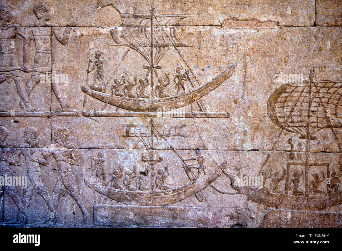 Ancient carvings of boats filled with people on the walls found at the temple of Idfu in Egypt. Stock Photo