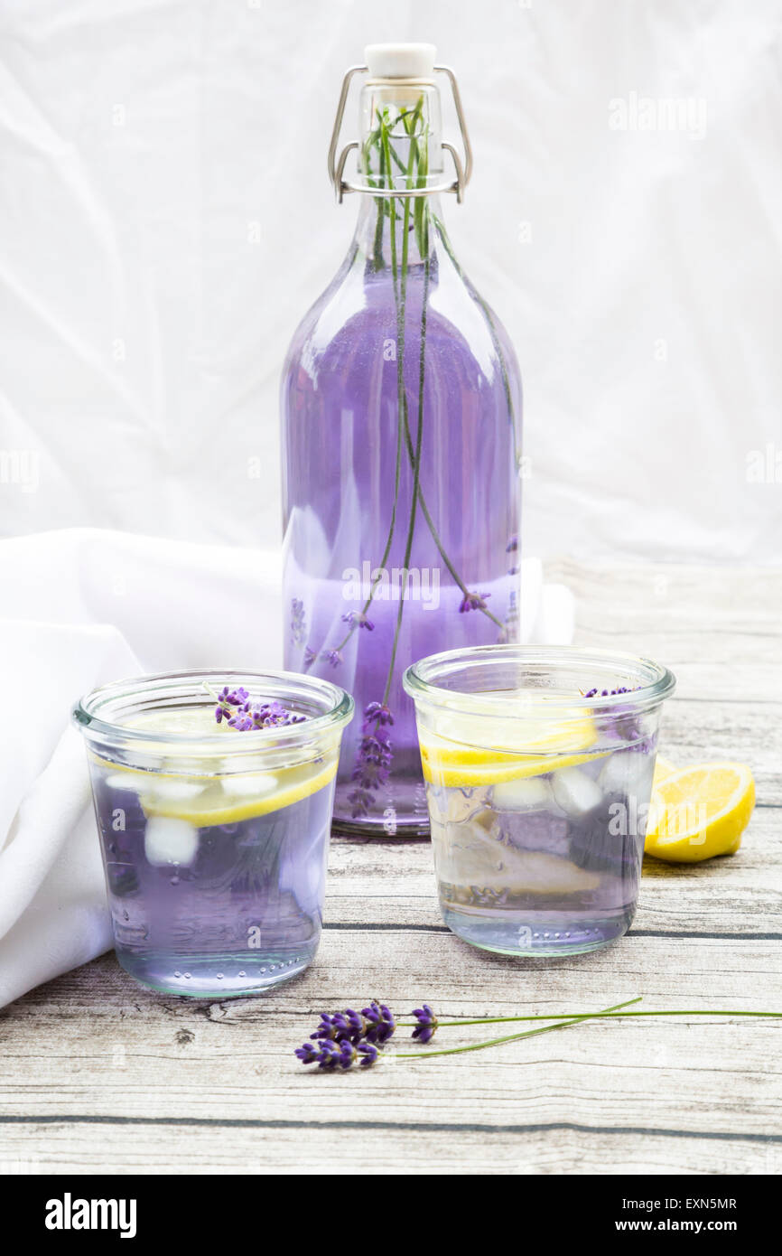 Homemade lavender lemonade, swing top bottle and glasses Stock Photo