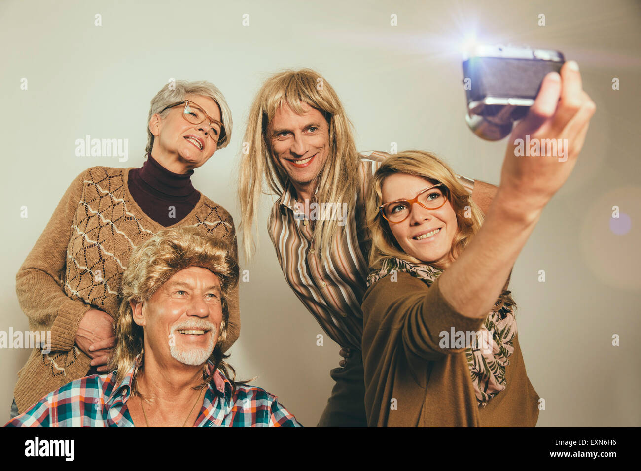 Family dressed like in the Eighties taking a selfie Stock Photo