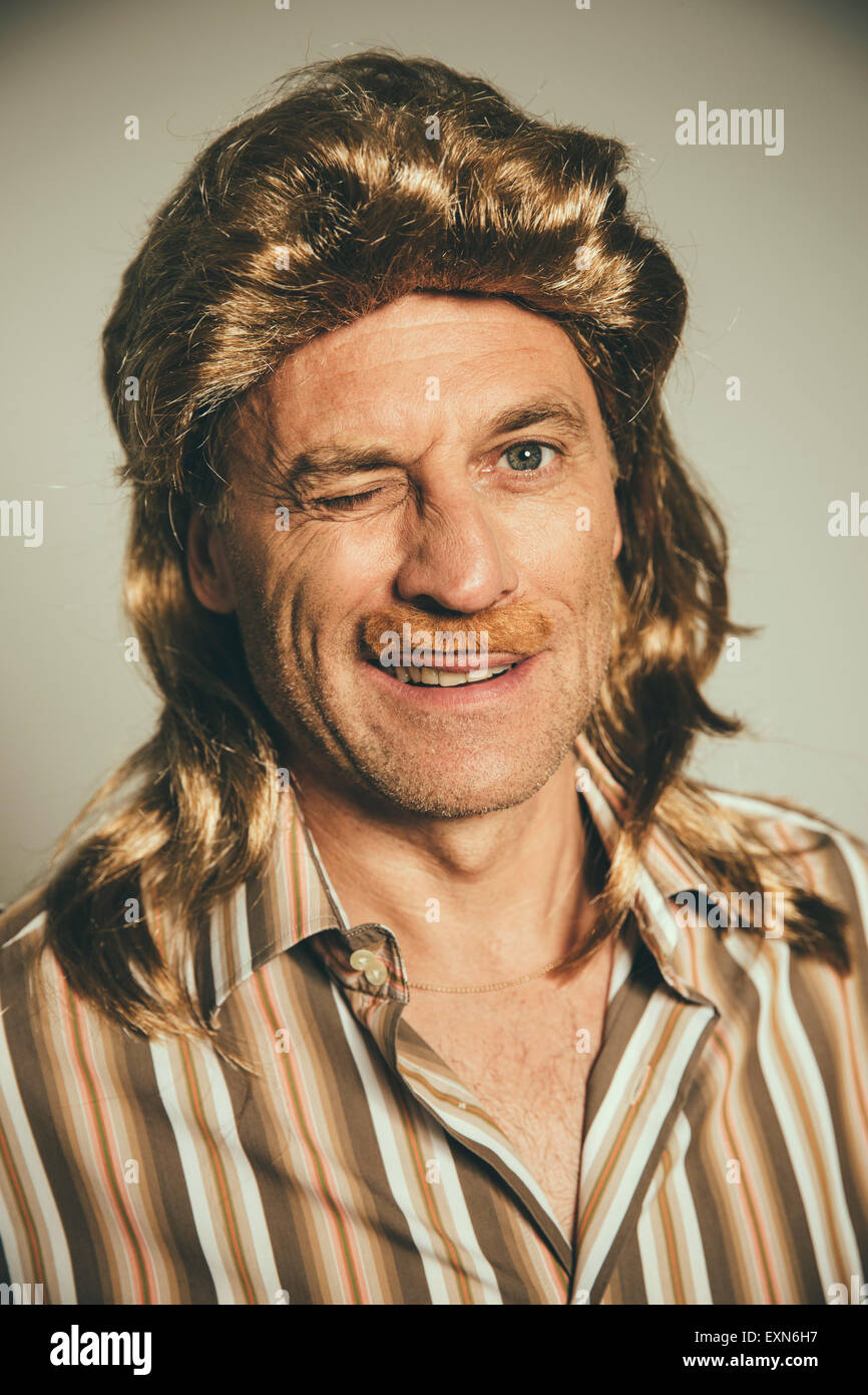 Portrait Of Winking Man With Wig And Fake Moustache Stock Photo