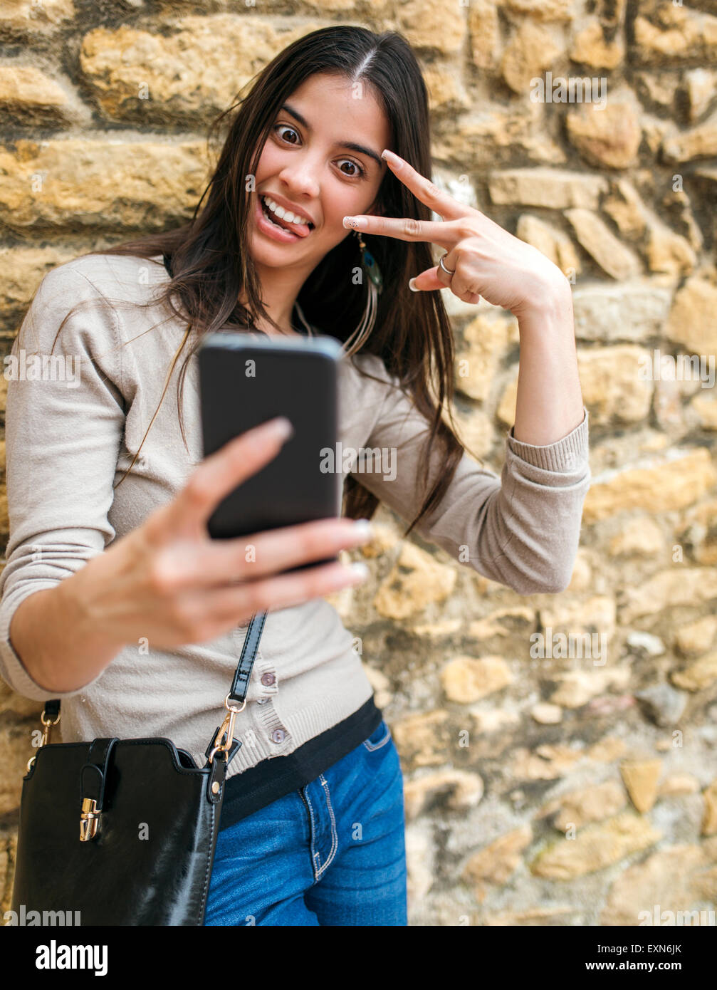 Young woman taking a selfie with her smartphone Stock Photo - Alamy