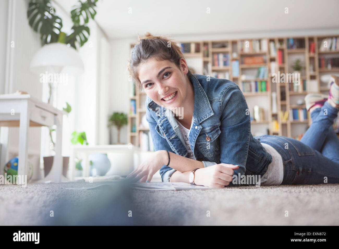 Portrait of smiling young woman relaxing at home Stock Photo - Alamy