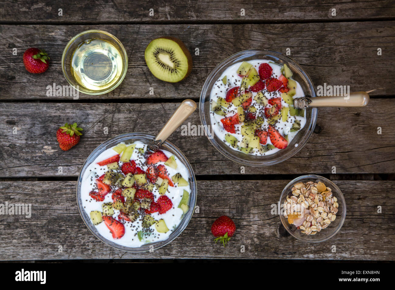 Strawberry kiwi yogurt with cereals, chia seeds, agave syrup in glass