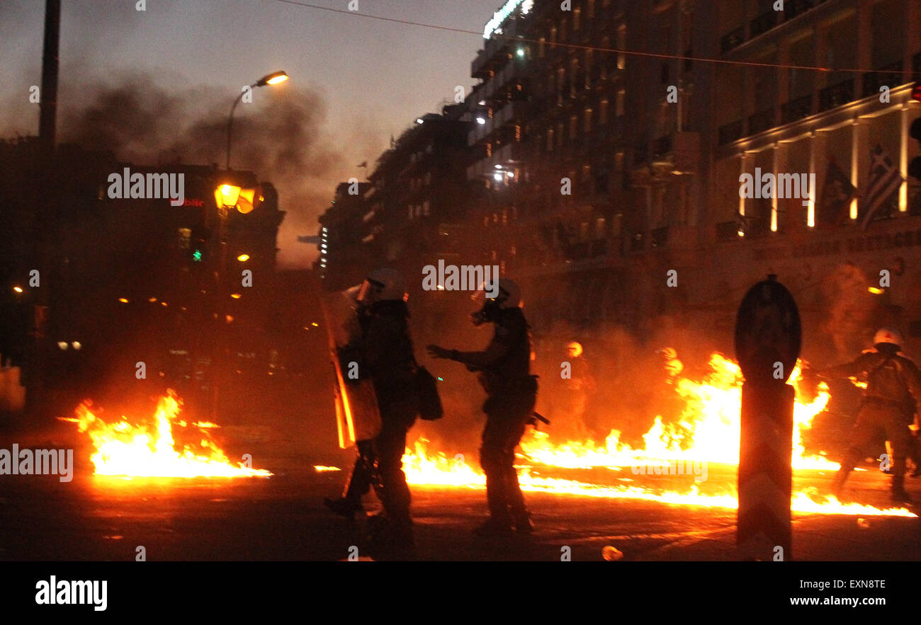 Athens, Greece. 15th July, 2015. Anti-bailout protesters clash with riot police in Athens, Greece, July 15, 2015. Anti-austerity protests organized by trade unions and opposition parties on Wednesday evening in front of the Greek parliament have been marred with violent clashes which broke out between protestors and anti-riot police. Credit:  Marios Lolos/Xinhua/Alamy Live News Stock Photo