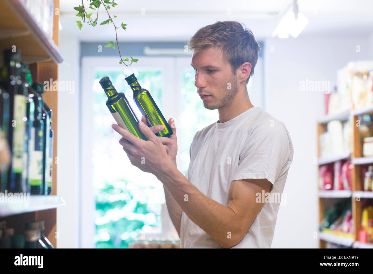 Male shop assistant sorting merchandise in wholefood shop Stock Photo