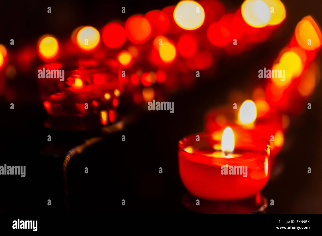 Lighted votive candles in a church Stock Photo - Alamy