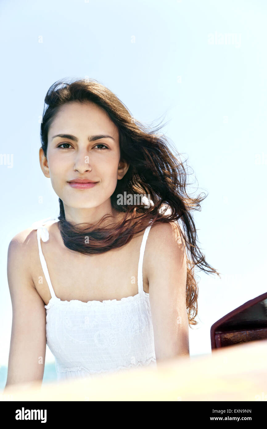 Portrait of smiling brunette young woman outdoors Stock Photo - Alamy