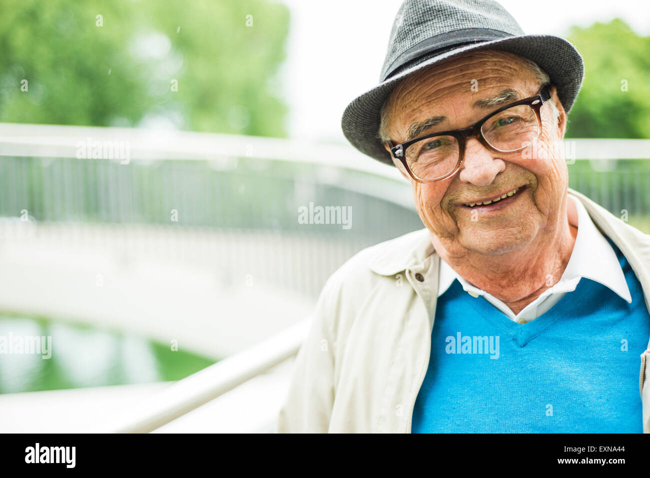 Portrait of smiling senior man wearing glasses ans and hat Stock Photo