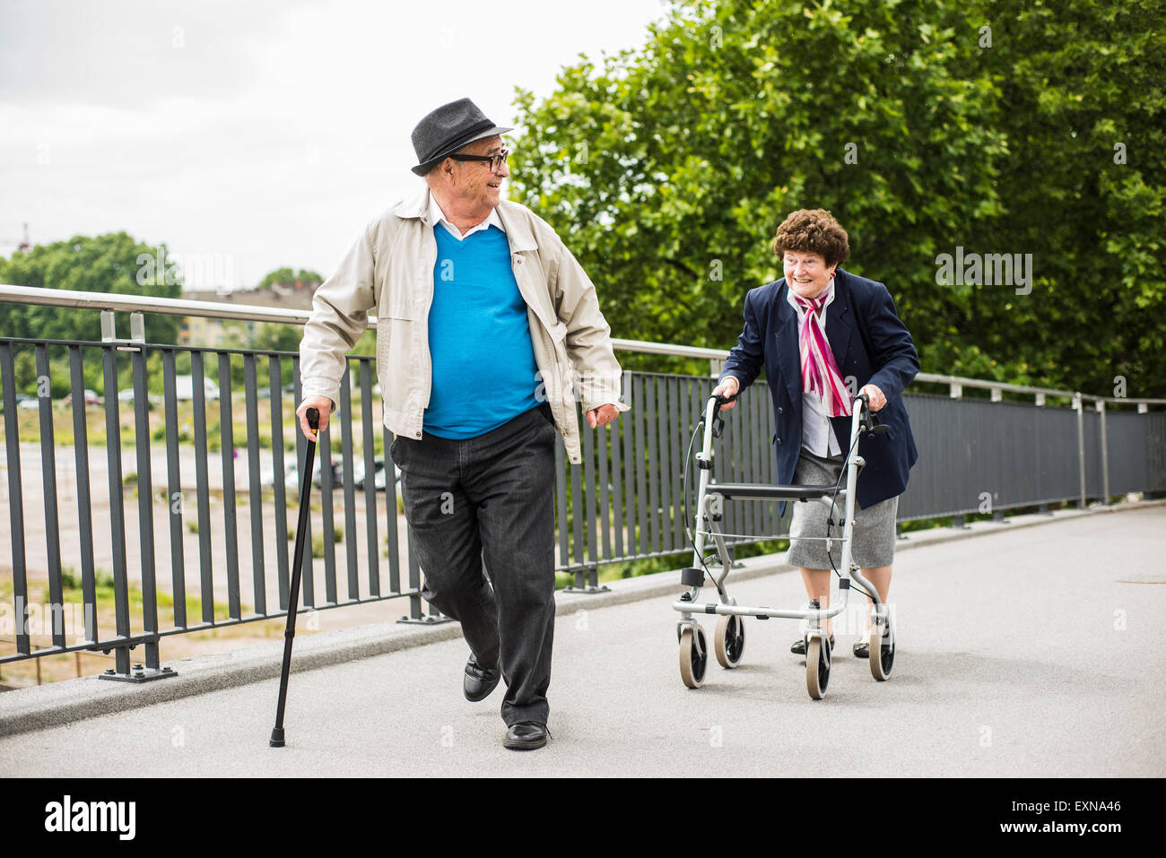 Senior couple with walking stick and wheeled walker Stock Photo