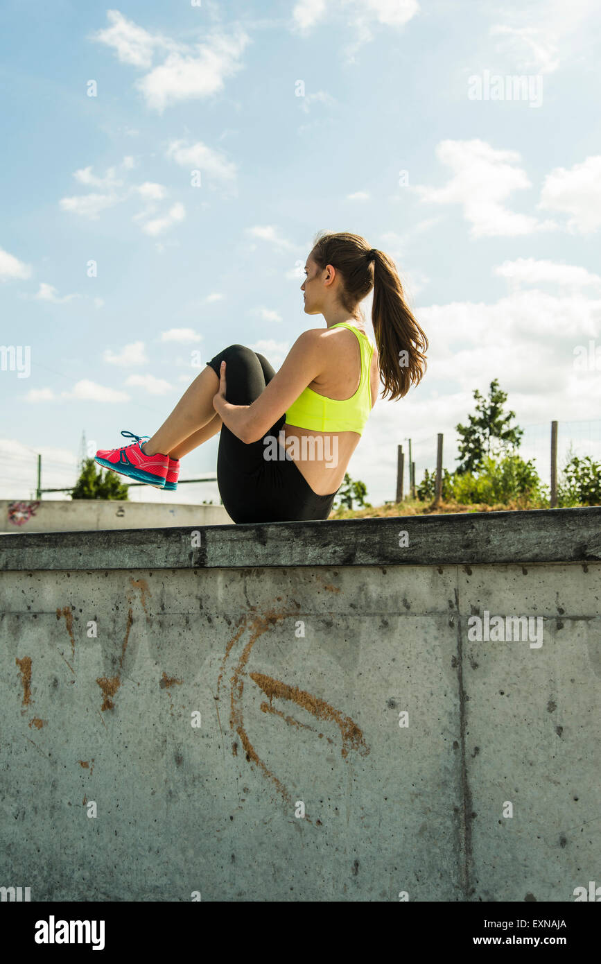 Young woman doing stretching exercises on a wall Stock Photo - Alamy